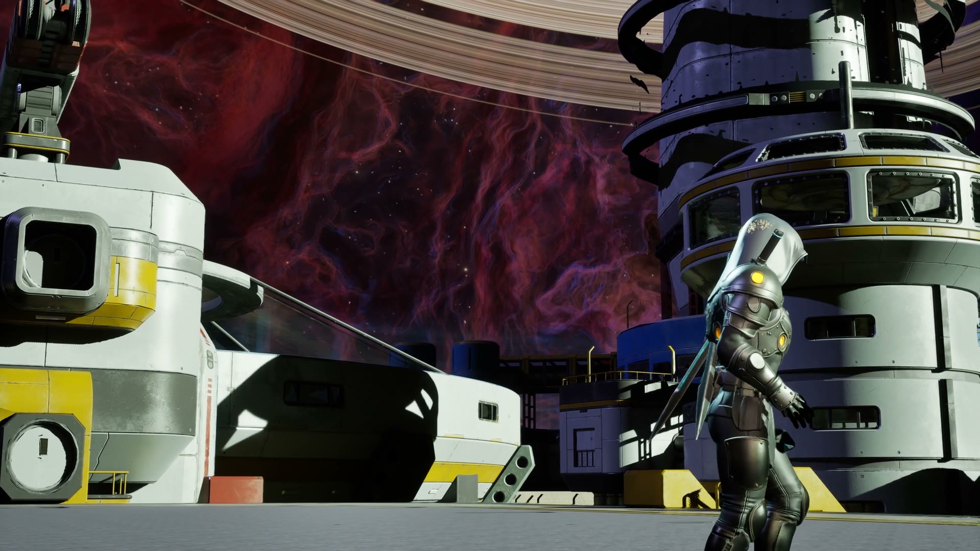 The hero walks the camp deck past its modules and spiral tower